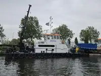 Multicat multipurpose vessel with hydraulic crane & spud pole legs